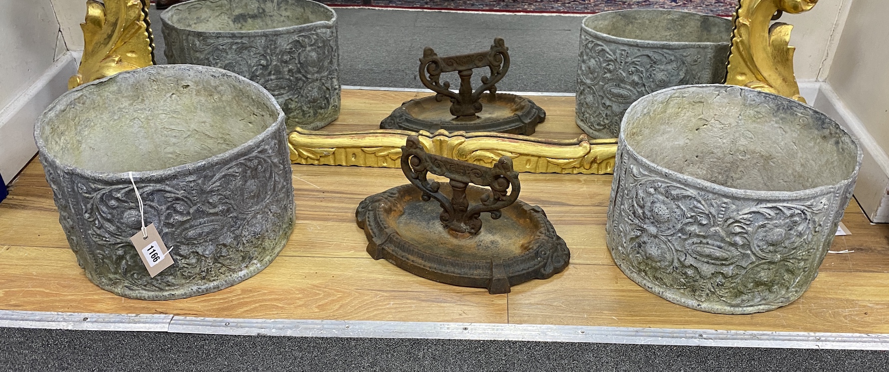 A pair of circular lead garden planters, diameter 34cm, height 21cm together with a cast iron boot scraper